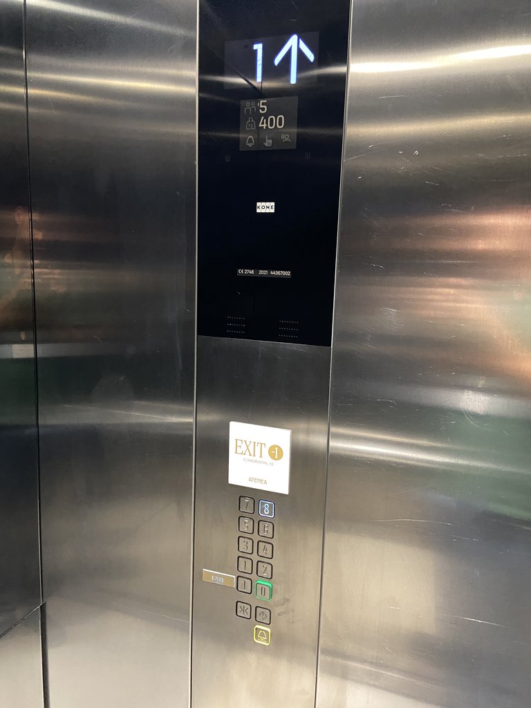 Accessible elevator, equipped with visual notices, braille buttons, and the panel at the correct height. It also has signage indicating the exit street of the establishment.