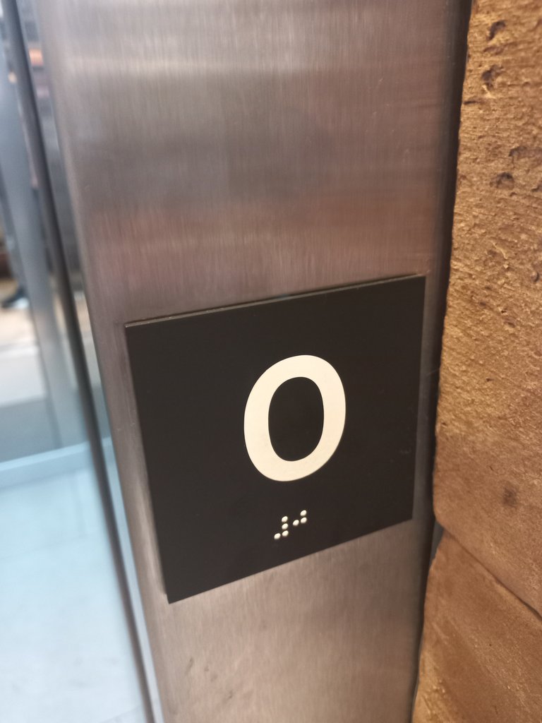 Floor signs at elevator exits with Braille system.