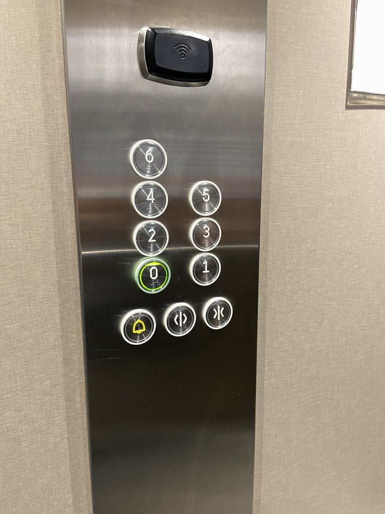 Accessible elevator with buttons at appropriate height, braille buttons, and equipped with visual and acoustic alert systems.