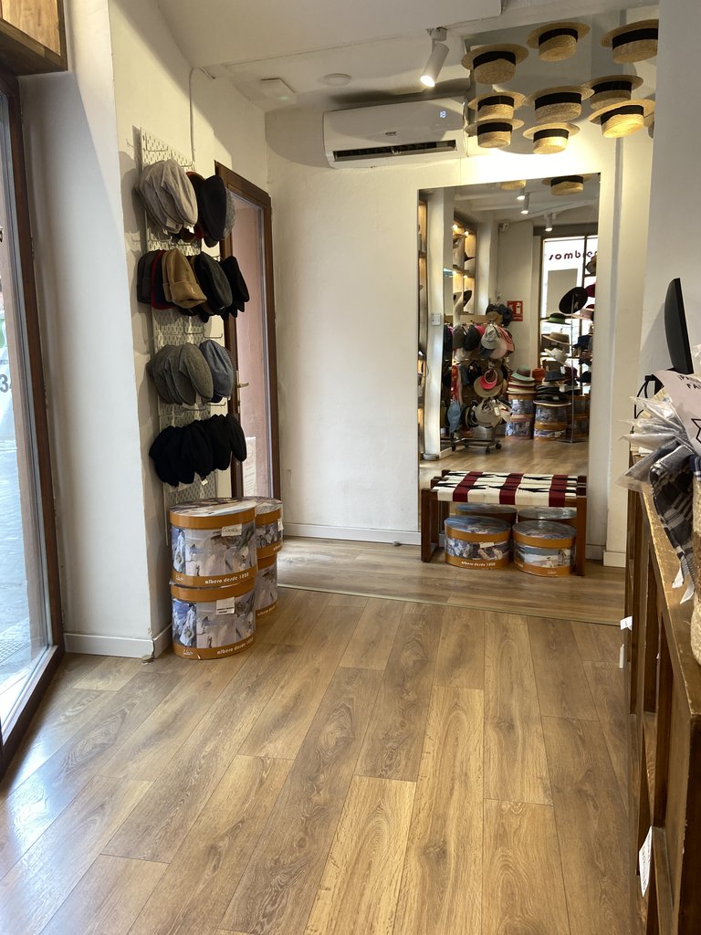 Spacious fitting room area with a mirror at the appropriate height for use by all types of users.