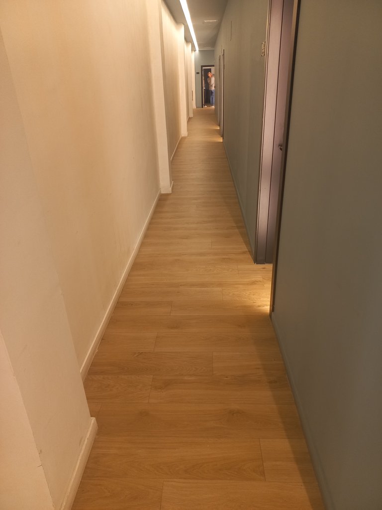 Common areas with uniform lighting and floor contrasted with vertical parameters.