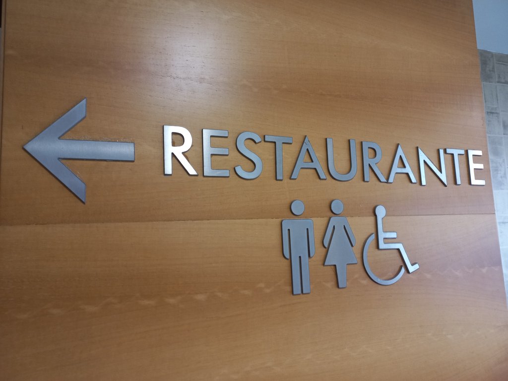 Signage with text, pictogram, and directional indicator.