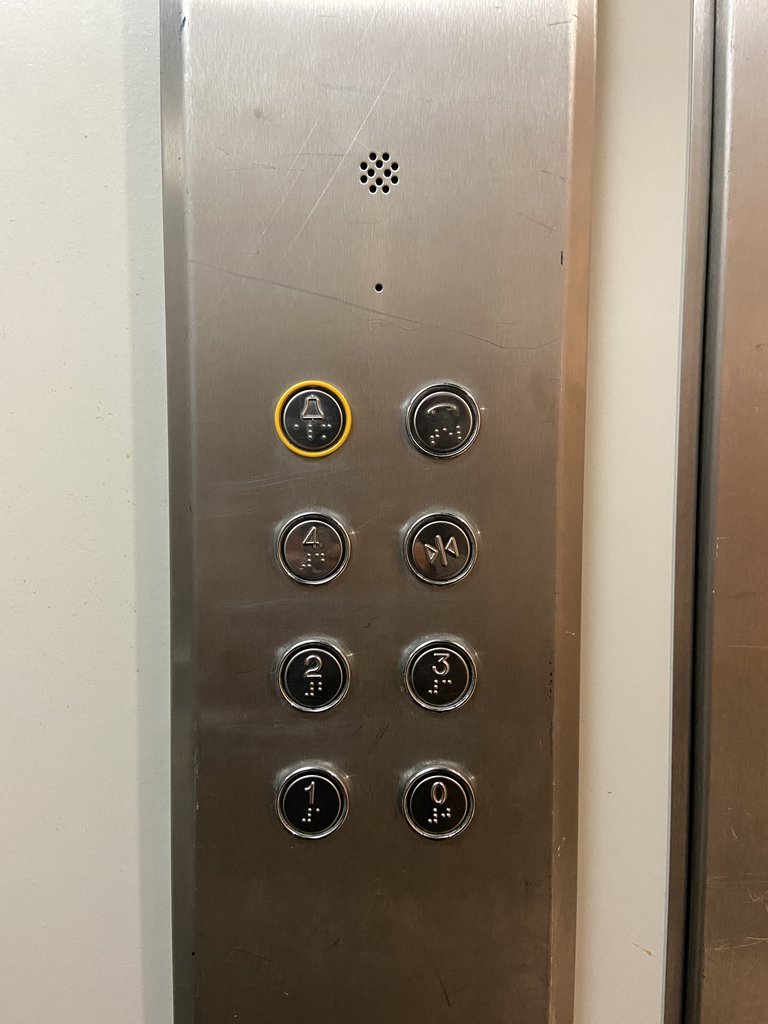 Elevator equipped with braille buttons and set at appropriate height.
