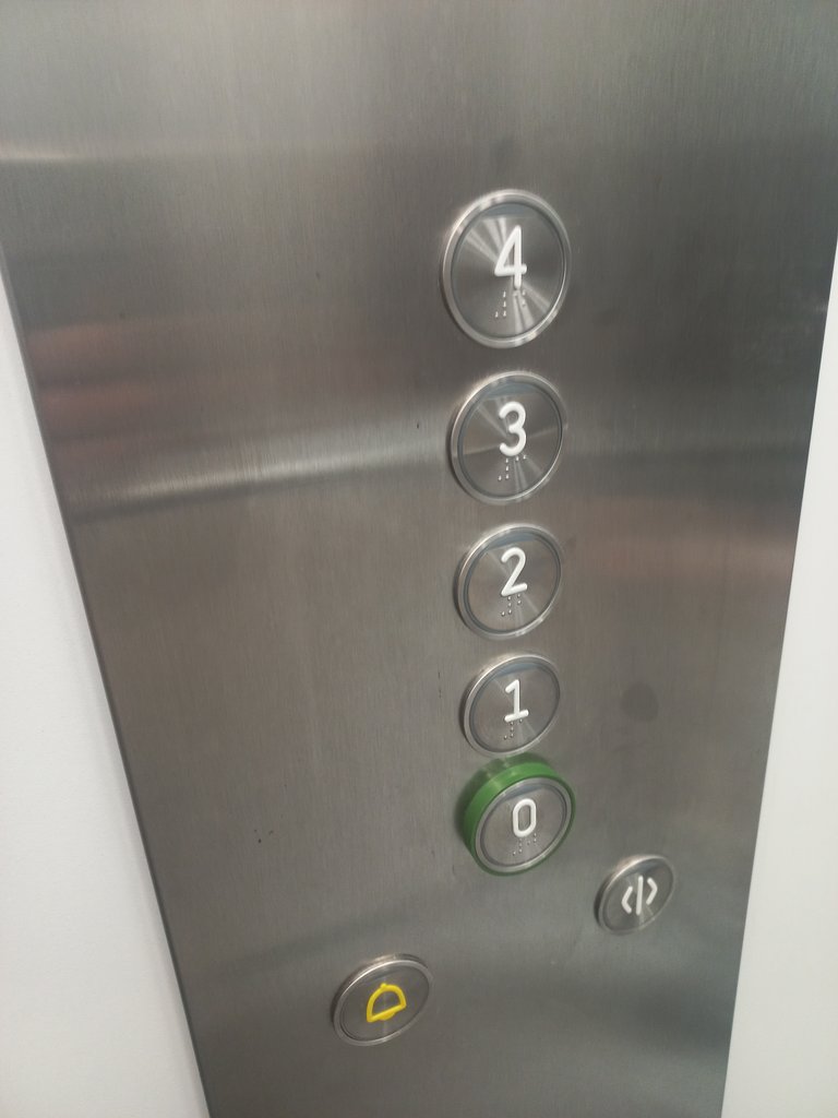 Accessible button panel at appropriate height with communication system in braille and high relief.