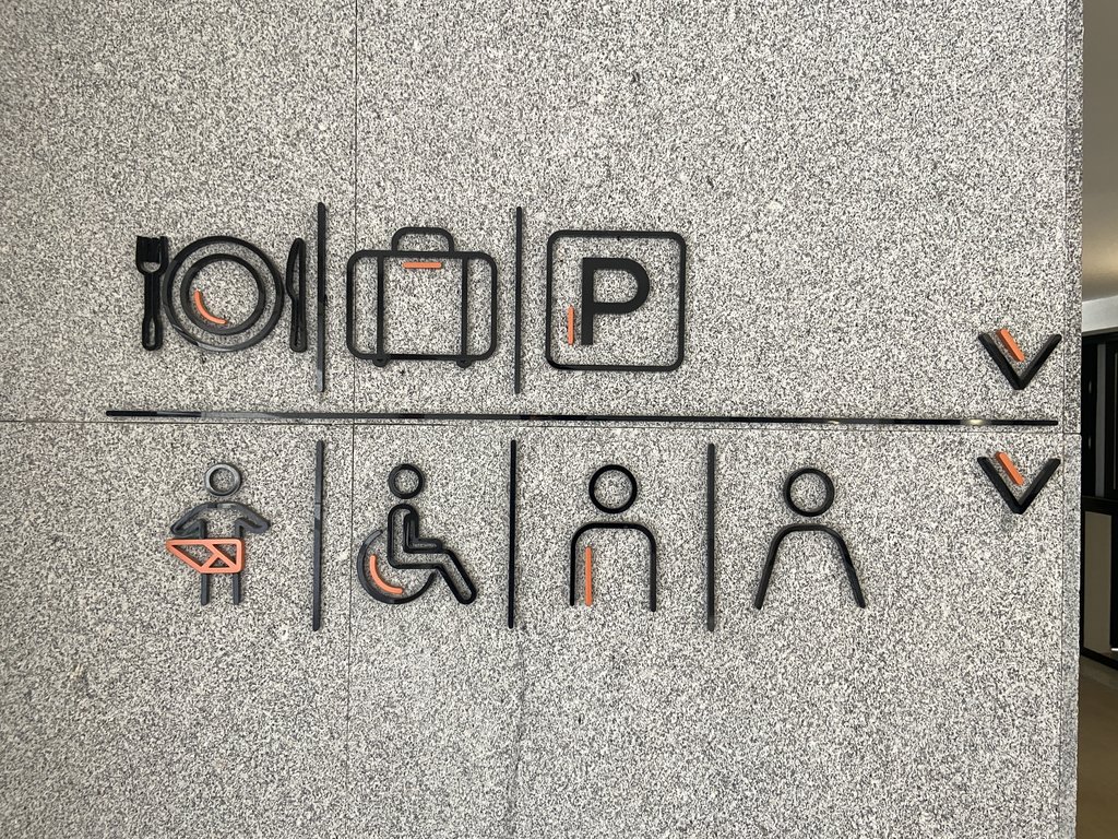 Pictogramas en alto relieve indicando la dirección espacios.