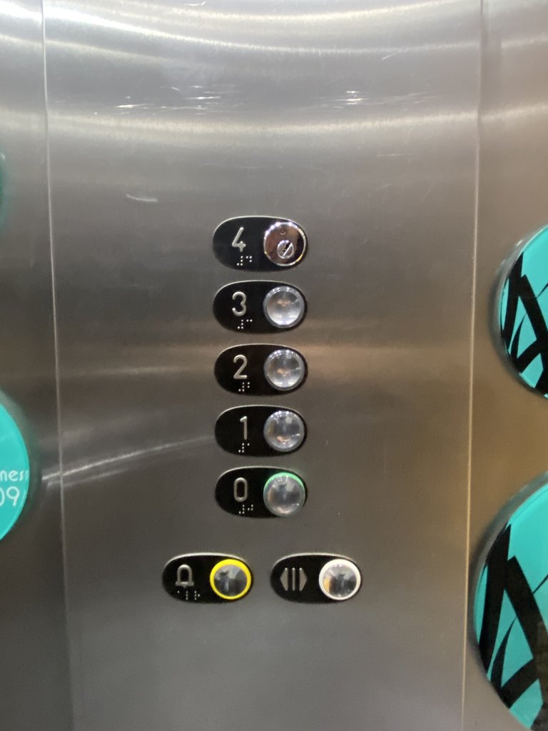 Accessible elevator, equipped with braille buttons and control panel at appropriate height.