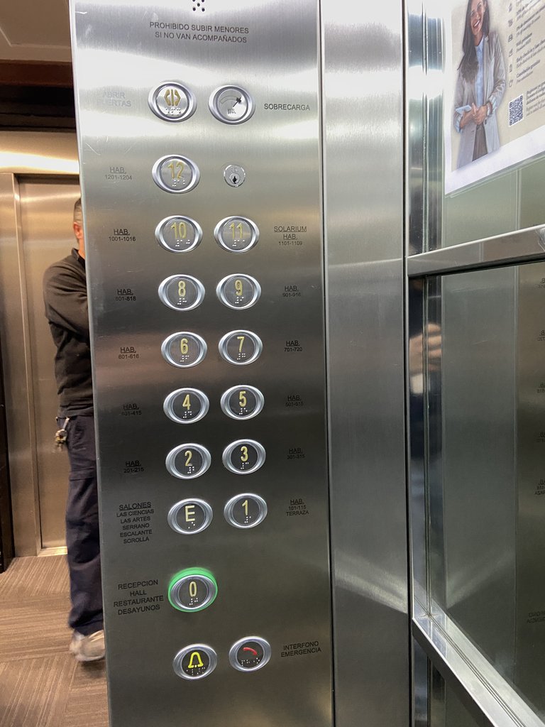 Accessible elevator, buttons in braille and illuminated, with floor space indications.