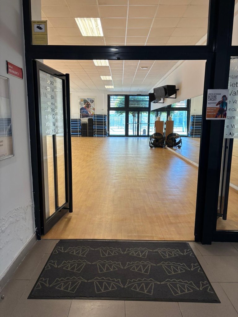 Accessible fitness area access with proper width and adequate lighting.