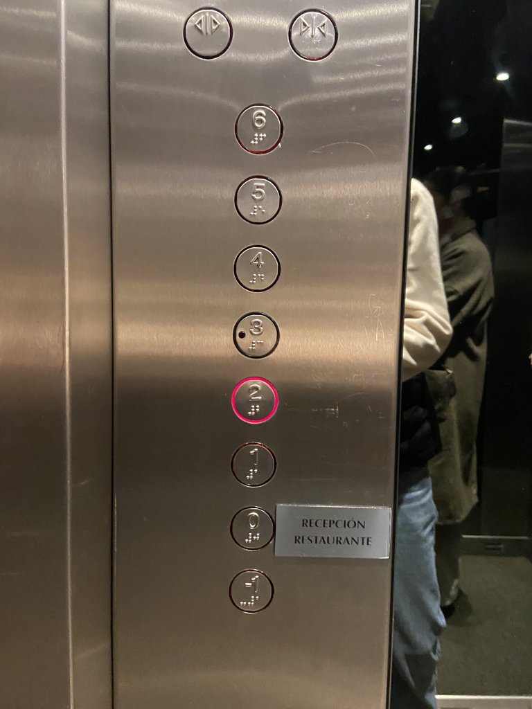 Accessible elevator with braille and illuminated buttons.