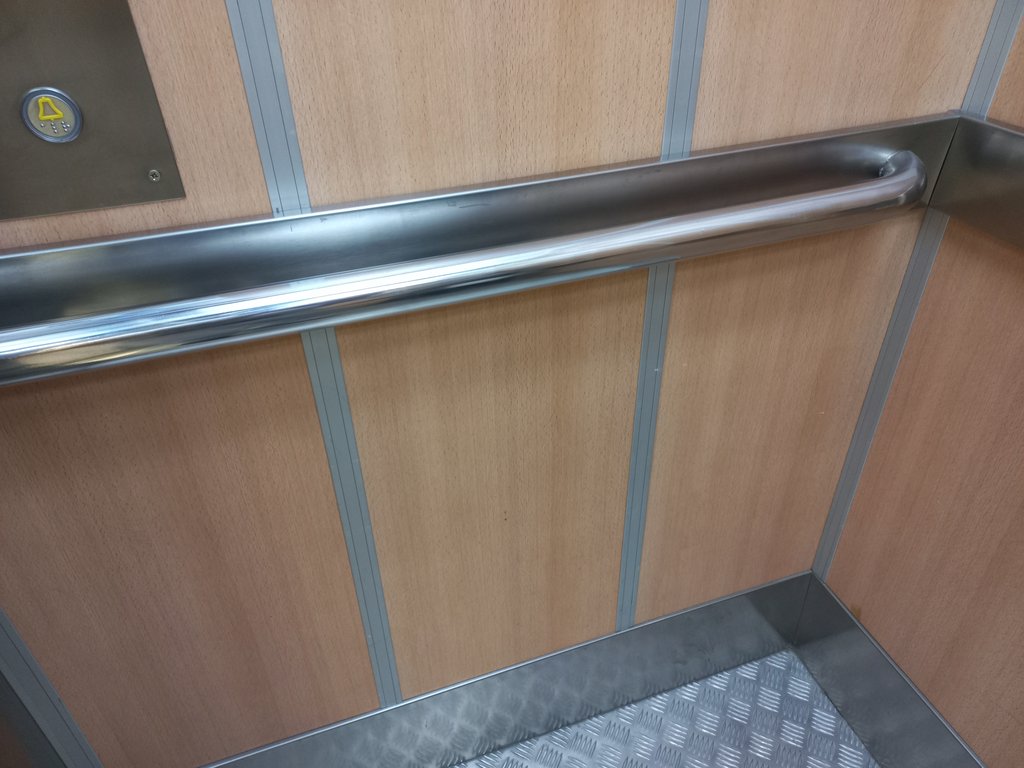 Elevator cabin with handrails