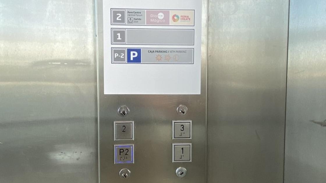 Accessible elevators with braille and illuminated buttons, control panel at appropriate height, and floor signage.