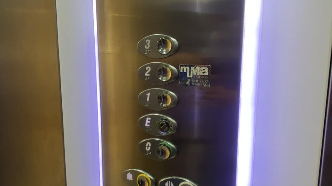 Accessible elevator with control panel at appropriate height, with braille and illuminated buttons.