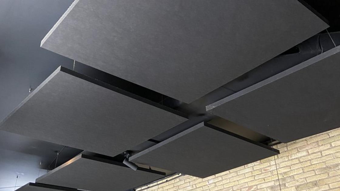 Dining room prepared with noise-absorbing panels on the ceiling.