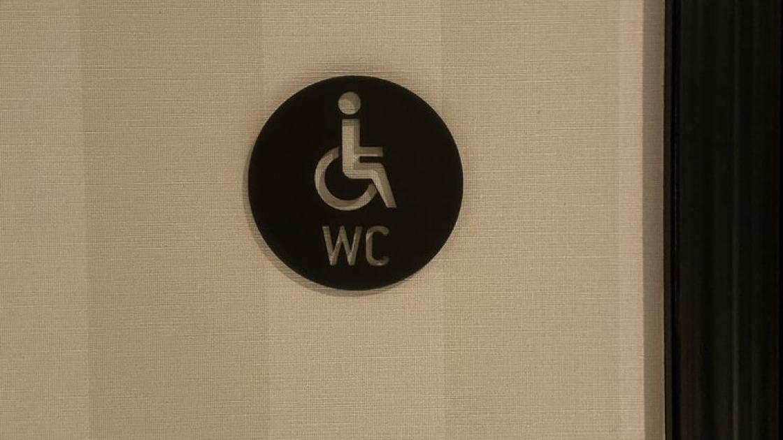 Signage for adapted bathroom in common bathrooms.