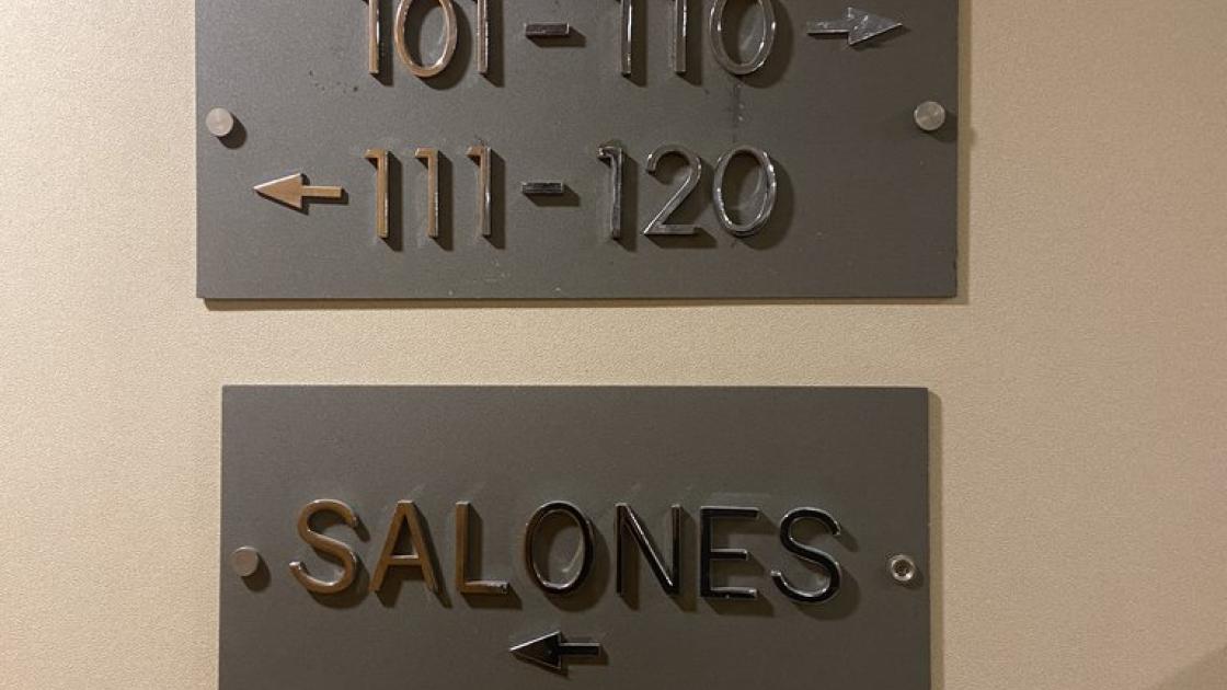 Signage, room and hall directions in high relief.
