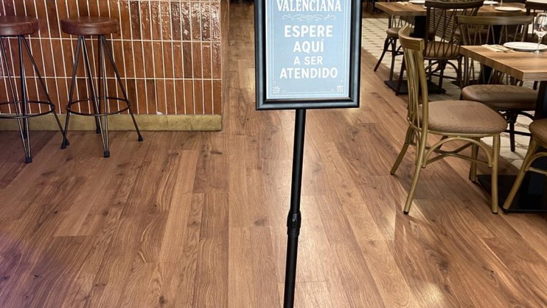 Signage, next to the door, for customer service waiting.