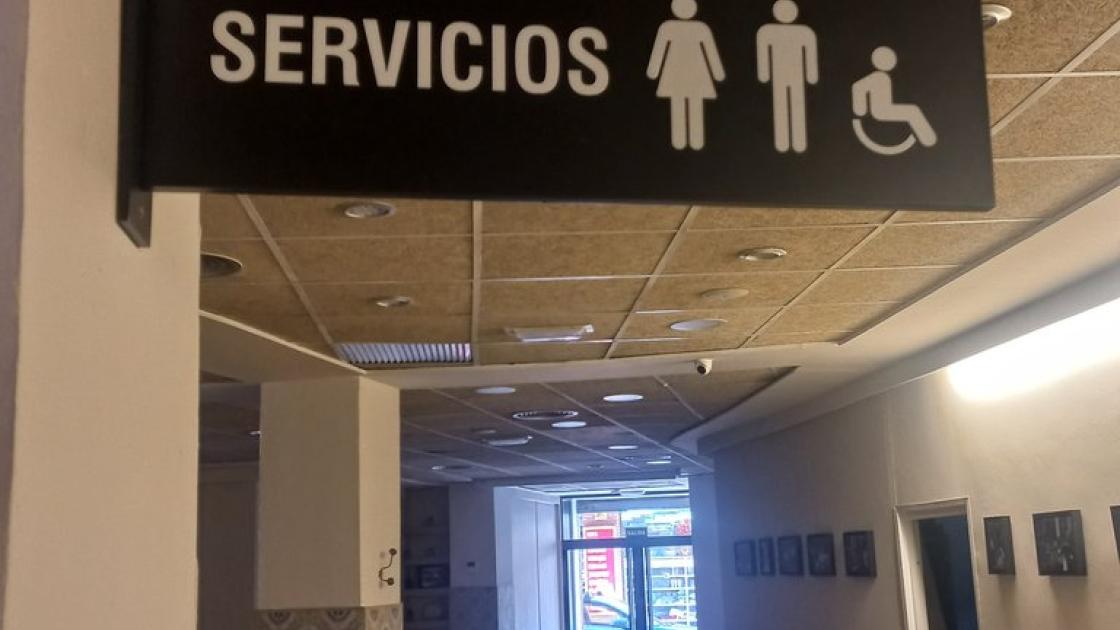 Signage with text and pictogram composition.