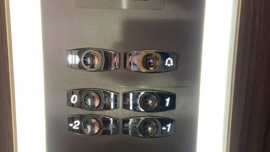 Accessible elevator, equipped with braille buttons and illuminated, with controls at an appropriate height.