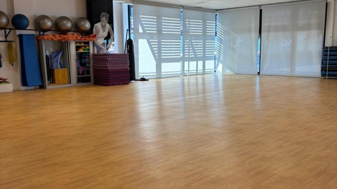 Sala de fitness accesible con espacio suficiente para entrenar cómodamente y bien iluminada.
