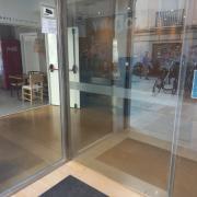 Acceso a través de puertas automáticas con bandas de contraste e identificación de vidrios.