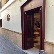 Main access to the establishment with swing doors and proper exterior accessibility.